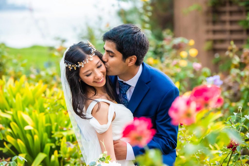 small wedding happy couple embracing in flower field