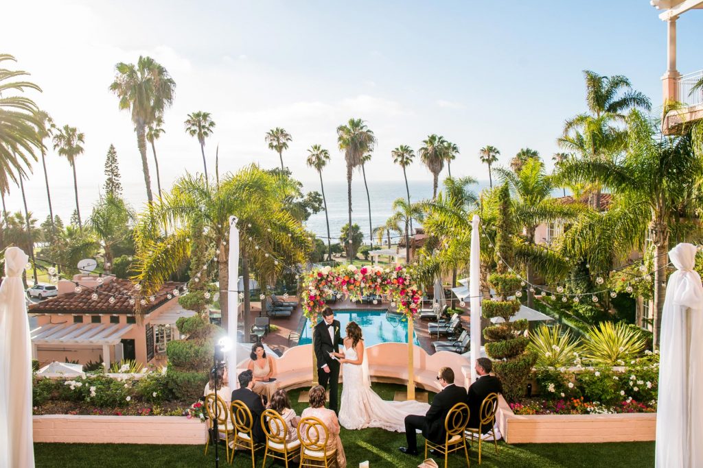 small wedding with palm trees in distance